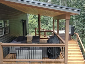 Deck with hot tub and outdoor seating