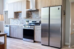 Full kitchen with stainless appliances.