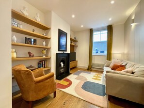 The cosy yet spacious living room boats feature fireplace and comfy seating