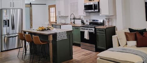 Modern kitchen with gas stove, microwave, refrigerator/freezer & dishwasher