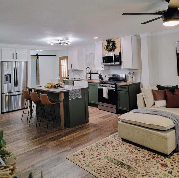 Modern kitchen with gas stove, microwave, refrigerator/freezer & dishwasher