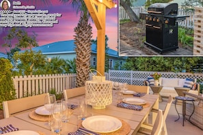 A view of the fenced in backyard with a bbq grill and outdoor games set up.