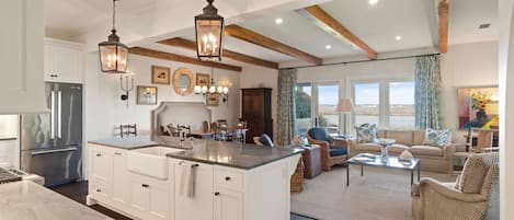 View from entry to kitchen of island, great room, and gorgeous marsh views 