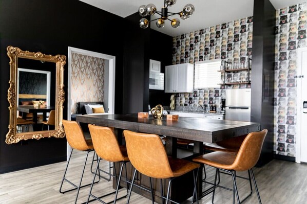 Fully equipped kitchen with drip coffee maker + coffee. Dining table with seating for 8. Full length mirror for getting ready. This room opens up into the living room. Unique wallpaper all throughout the condo.