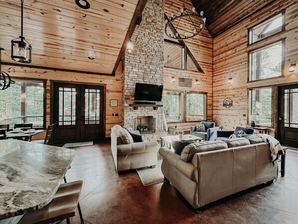 When the log cabin charm meets modern comfort! Can you picture yourself curling up by that fireplace?