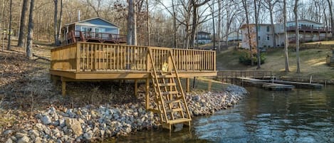 Fish or swim from this large lakeside deck with ship's ladder extending into the water. The dock to the right belongs to neighbors and isn't available for use.