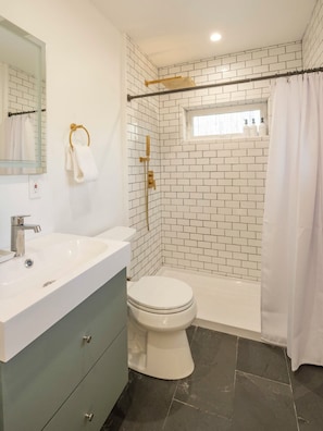 The bathroom is bright, spacious and clean with a large walk-in shower.