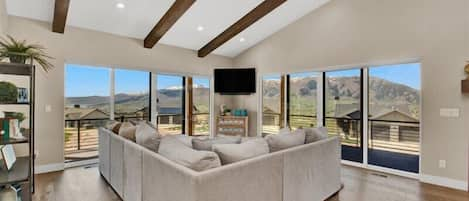 Living room with wrap-around deck.  Views of Pineview Reservoir, Snow Basin, and Nordic Valley.