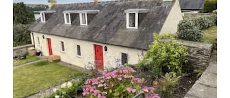 The cottage, one of a pair of the 17th century Alms cottages. 