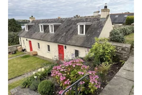 The cottage, one of a pair of the 17th century Alms cottages. 