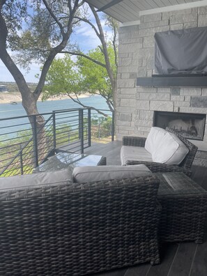 view from 1st level deck, BBQ, refrigerator, TV, fireplace.