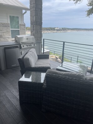 view from 1st level deck, BBQ, refrigerator, TV, fireplace. 