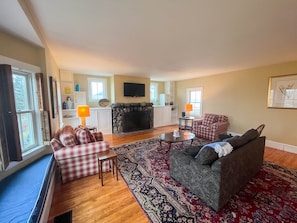 Large back living room with 55" TV and views of backyard