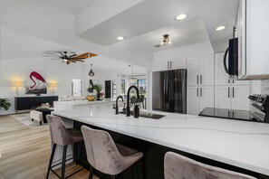 Full, open concept kitchen views main living room. 