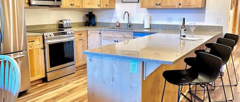 Kitchen with peninsula facing great room.