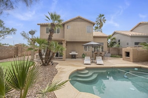 View from the backyard! Putting green, dip pool, outdoor seating/fireplace.