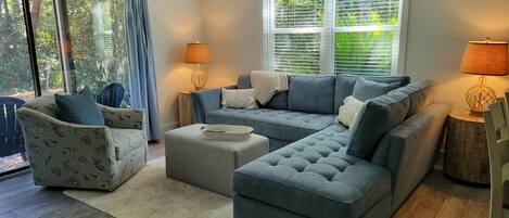 All new furniture awaits in this bright den with views of the surrounding trees.