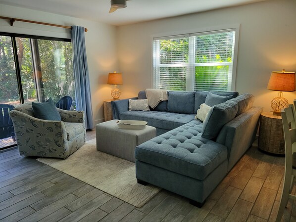 All new furniture awaits in this bright den with views of the surrounding trees.