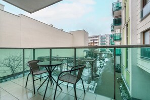 The furnished balcony offers a perfect spot for morning coffee with a view.