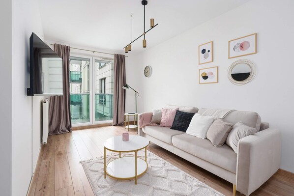 Relax in the stylish living room with a comfortable sofa and modern decor.