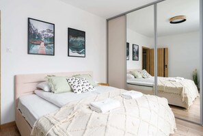 The cosy bedroom features a luxurious double bed and ample storage.