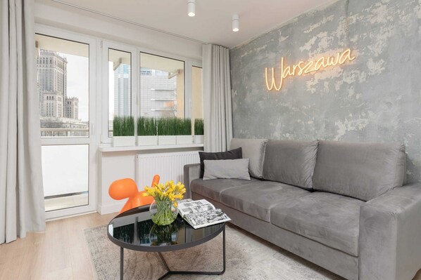 Relax in the stylish living room with a comfortable sofa and modern decor.