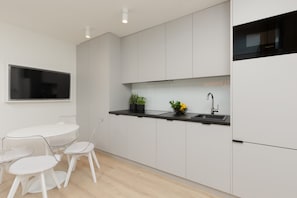 Cook and dine in style with the modern kitchenette and dining area.