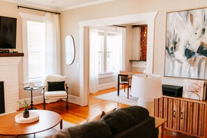 The open floor plan and beautiful natural light flowing in through the large windows make the kitchen and living room the perfect place to hang out as a whole family or group.