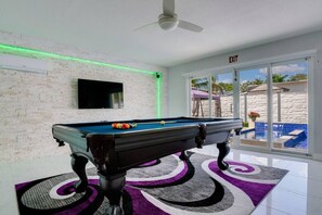 Den area with pool table and smart TV