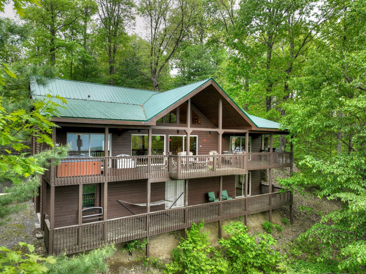 Hummingbird Haven is the ultimate retreat for large groups! Enjoy pet-friendly accommodations, breathtaking mountain views, a hot tub, firepit, WiFi, and hiking