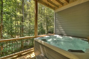 Soak in the hot tub with a view of the rambling creek below