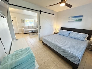 Private bedroom with barn door, king bed, smart HDTV