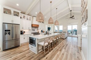 This Chef's Kitchen is Equipped with Kitchenaid Appliances including 2 Dishwashers, Gas Stove, Oven, Microwave, Full Sized Fridge & Pot Filler.