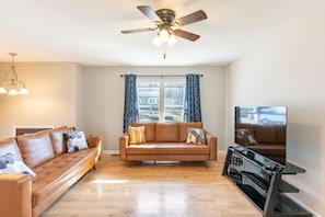 Living room on main floor , genuine leather , big TV, solid hardwood floor 