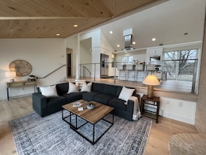 Sunken living room with fireplace and TV. Deck access on the lake side.