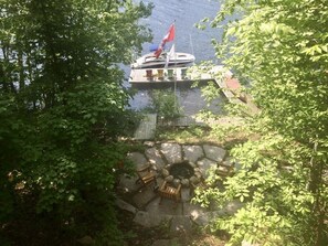 View of dock and fire pit from cottage deck.