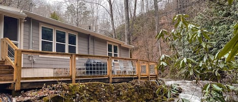 Enjoy the large deck that overlooks the roaring creek!