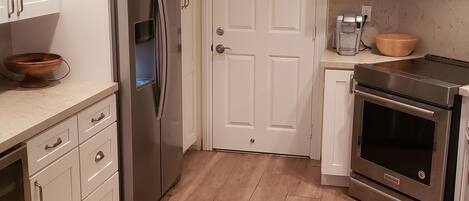 Galley kitchen with direct access to garage and laundry. 