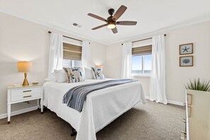 Primary bedroom w/ ocean views from both windows.