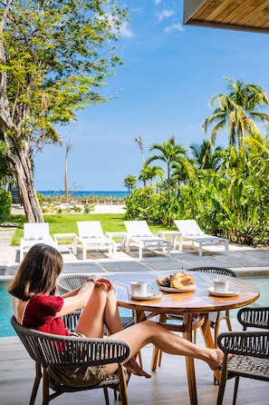 Enjoy breakfast of local fruits and  aromatic coffee while overlooking the ocean