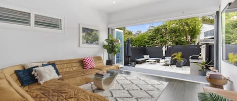 Open living room to a leafy terrace