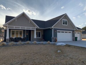 front of house with sitting area next to front door.  accessible with no steps inside the house both through the front door and the garage.