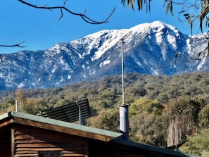 Snow-capped peaks rise beyond your cozy mountain hideaway.