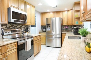 Fully equipped kitchen in our License to Chill, Largo vacation rental with heated pool.