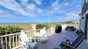 Large main deck with tables and gas grill