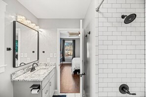 Step into the serene bathroom of our main suite, complete with a convenient shower/bathtub combination.