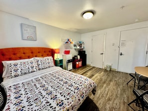 Micro studio apartment full size bed