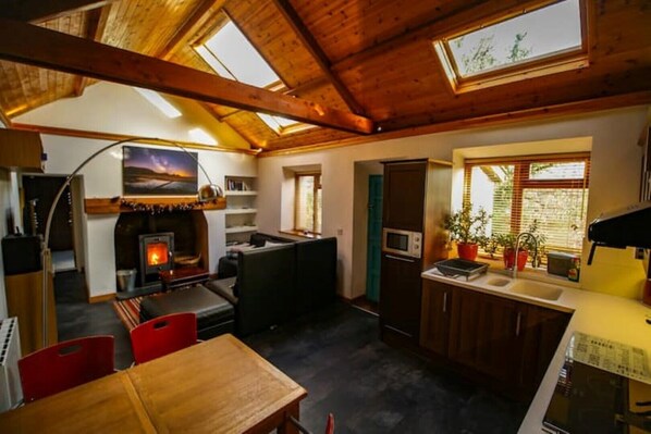 Large open plan living room with wood burner. 