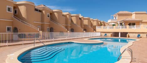 View of complex and communal gated pool