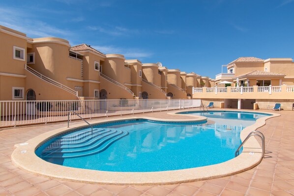 View of complex and communal gated pool